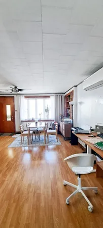 a living room with dining room and kitchen view