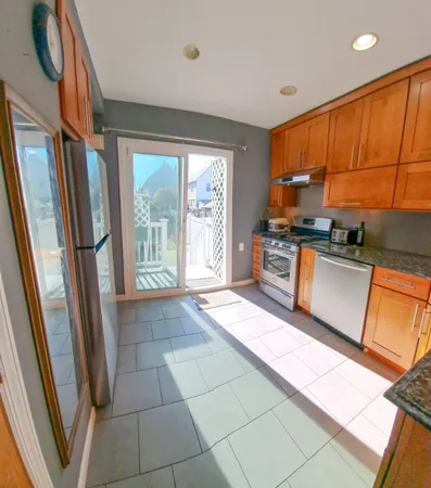 a kitchen with stainless steel appliances granite countertop a refrigerator and a stove
