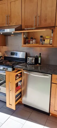 a close view of stove top oven and cabinets