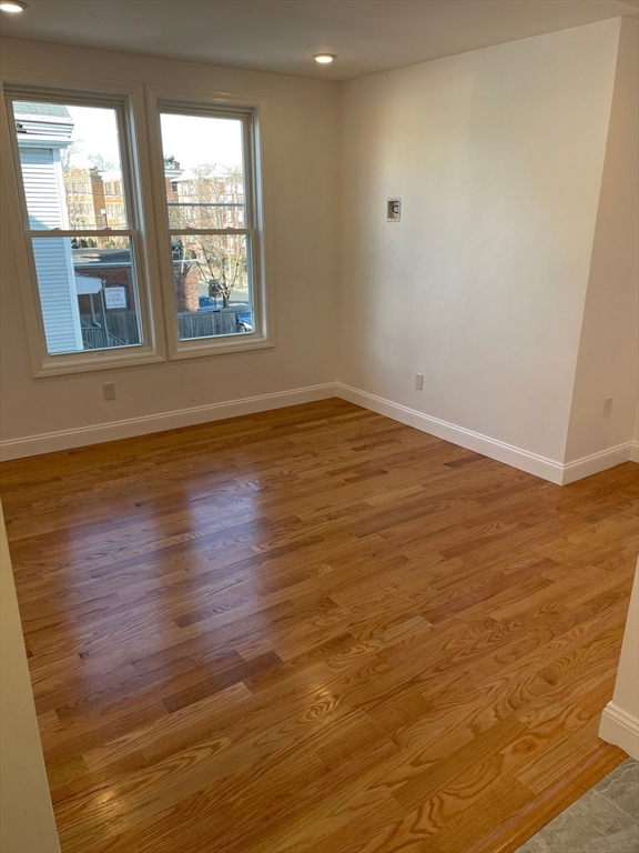 217 Washington Street, Unit 4L Lynn, MA 01902 - Photo 7 of 14 wooden floor in an empty room with a window