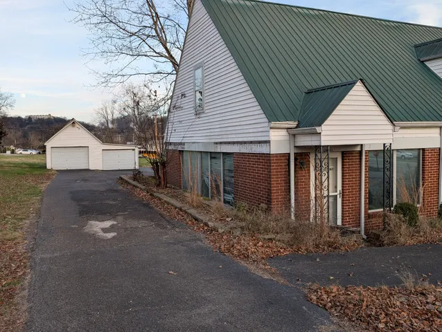 a view of a livingroom with a fireplace and window