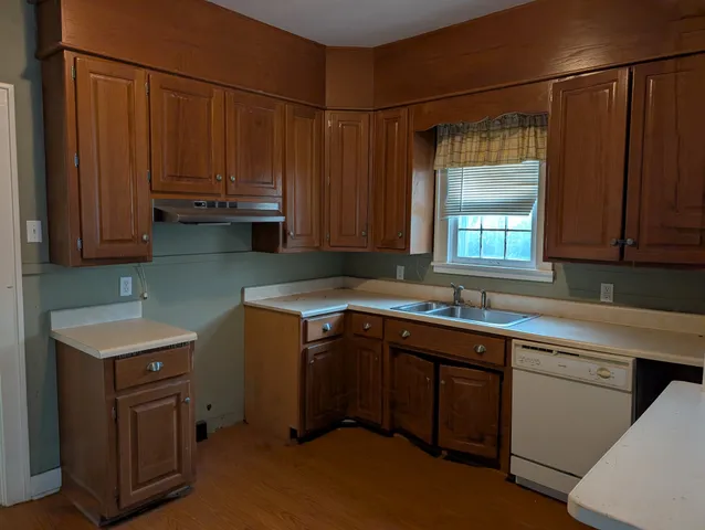a front view of a house with entryway and wooden floor