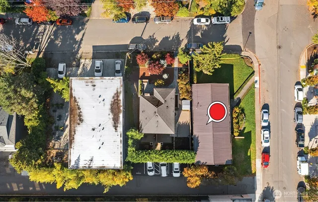 an aerial view of residential houses with outdoor space and swimming pool