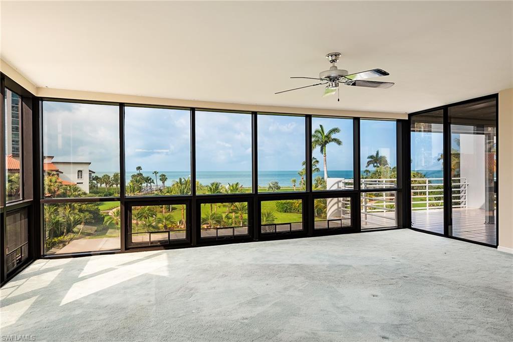 an empty room with sliding glass door and balcony