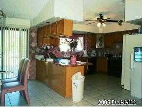 14 Remington Road Ormond Beach, FL 32174 - Photo 4 of 8 a kitchen with stainless steel appliances granite countertop a sink and a refrigerator