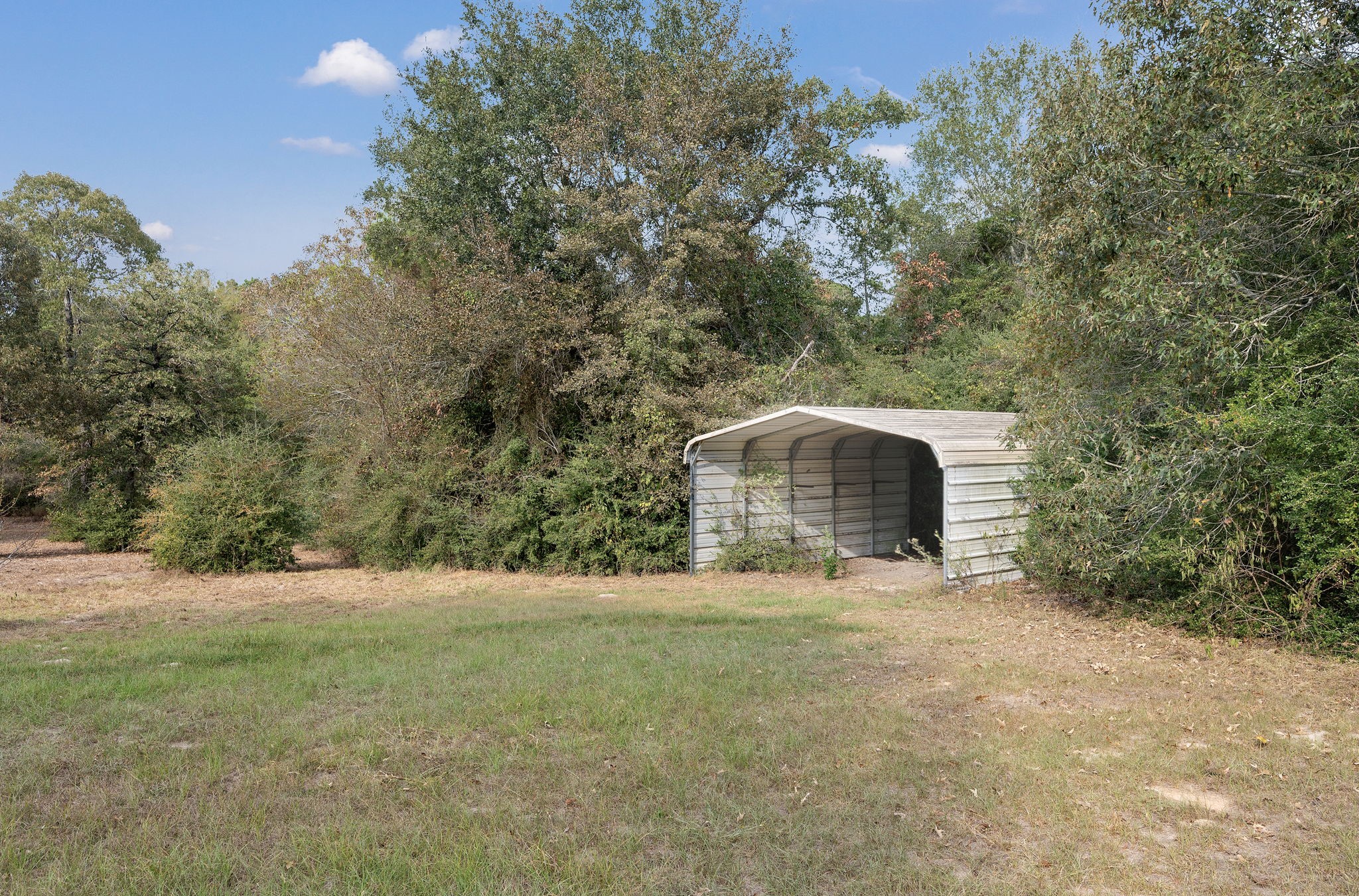 6493 Pappas Road Waller, TX 77484 - Photo 26 of 32 Massive covered RV and boat storage structure—a rare find for enthusiasts looking for unrestricted storage space.