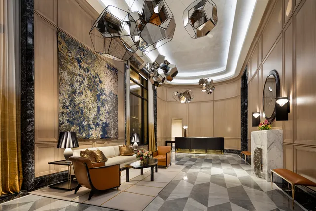 a lobby with furniture and a chandelier