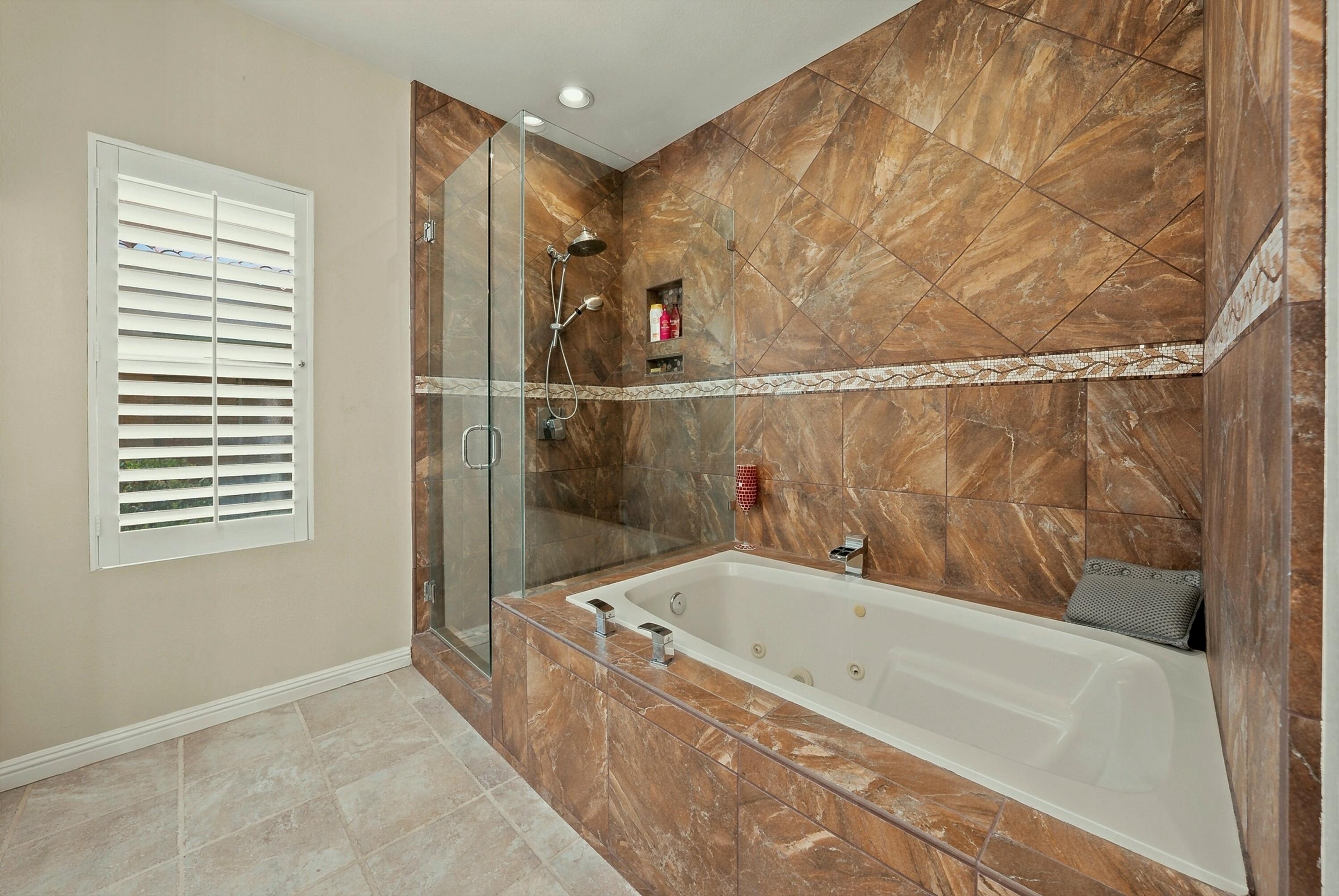 138 Lakeshore Drive Rancho Mirage, CA 92270 - Photo 18 of 30 a bathroom with a bathtub and a shower