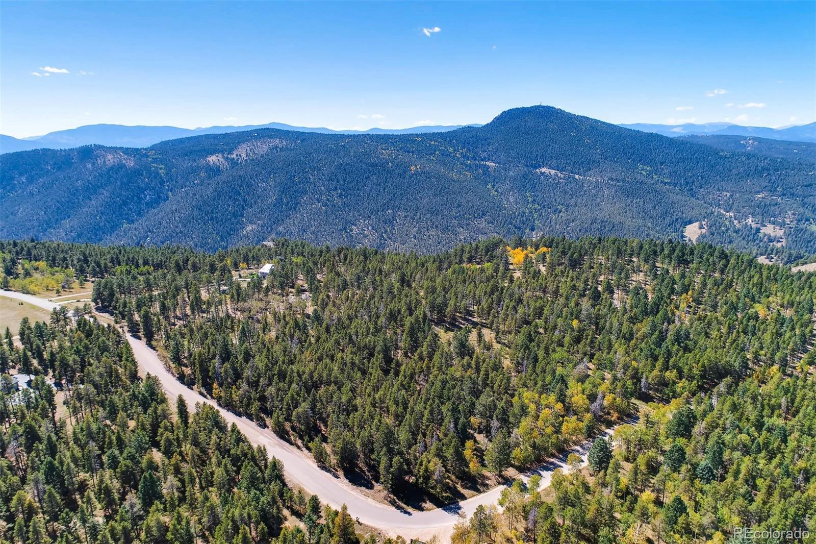 12171 South Ridge Road Conifer, CO 80433 - Photo 11 of 11 a view of a house with a mountain and a forest