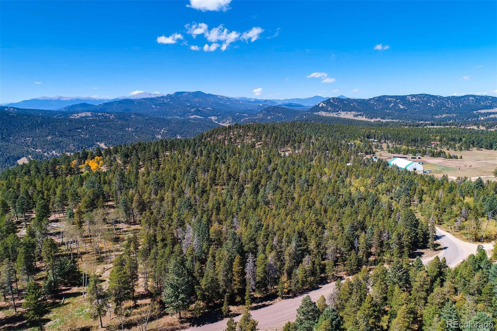 12171 South Ridge Road Conifer, CO 80433 - Photo 3 of 11 a view of a city with mountains in the background