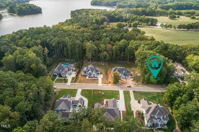 an aerial view of a house with garden space lake view and lake view