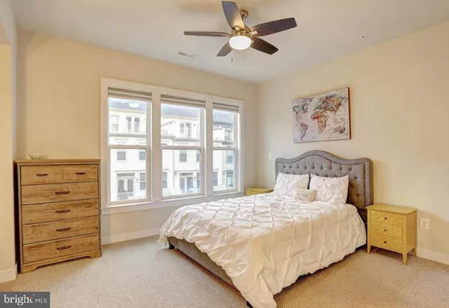 a spacious bedroom with a bed and a dresser