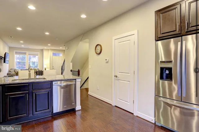 a kitchen with stainless steel appliances granite countertop a stove microwave and sink