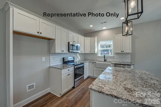 a kitchen with a sink stainless steel appliances and cabinets