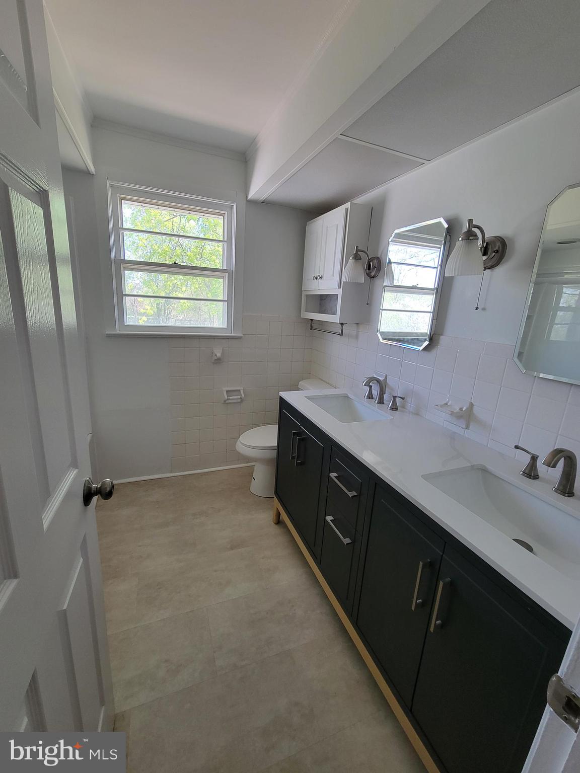 2671 Egypt Road Audubon, PA 19403 - Photo 16 of 25 a spacious bathroom with a double vanity sink a mirror and a toilet