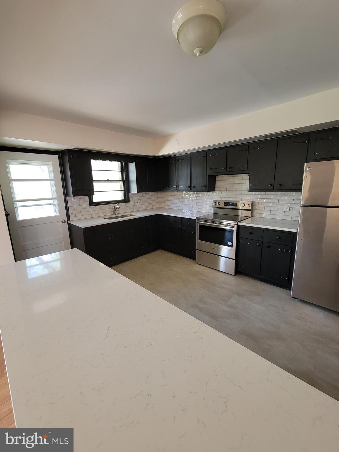 2671 Egypt Road Audubon, PA 19403 - Photo 6 of 25 a large kitchen with cabinets and wooden floor