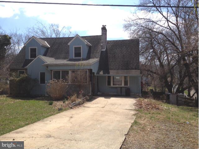 111 Heil Road Silver Spring, MD 20905 - Photo 3 of 4 a front view of a house with a yard and garage