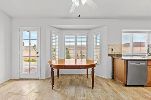 a kitchen with stainless steel appliances granite countertop a sink and a refrigerator