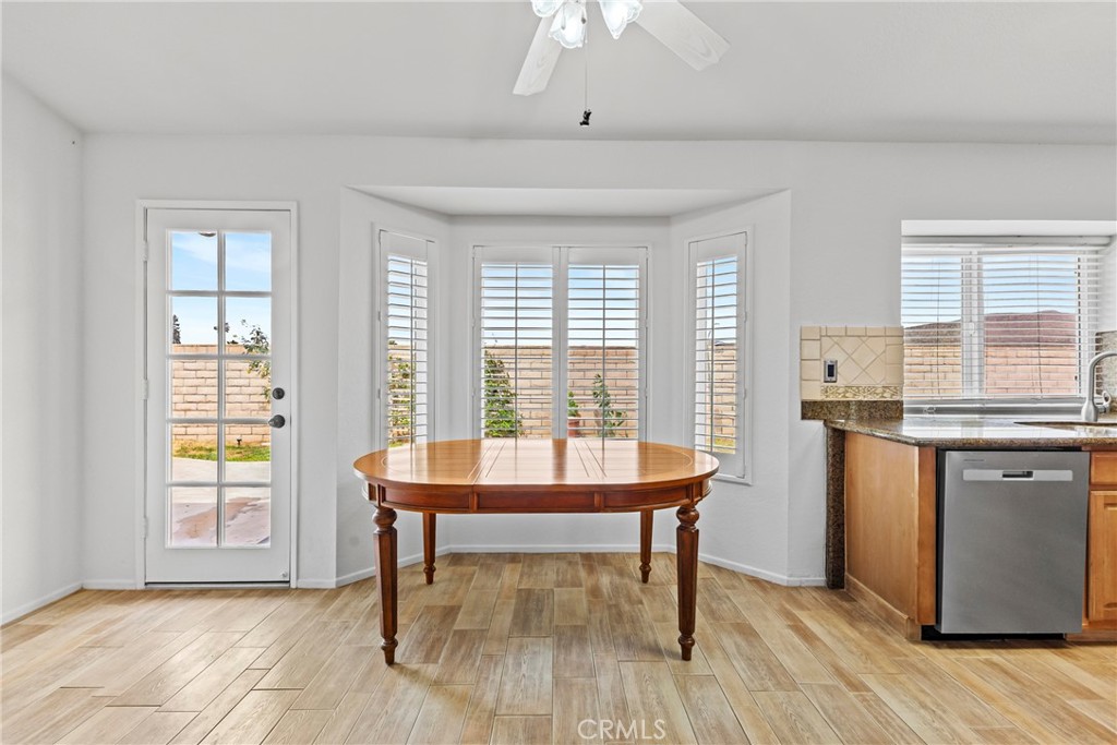 27126 Rio Vista Drive Menifee, CA 92586 - Photo 21 of 47 a dining room with wooden floor and a window