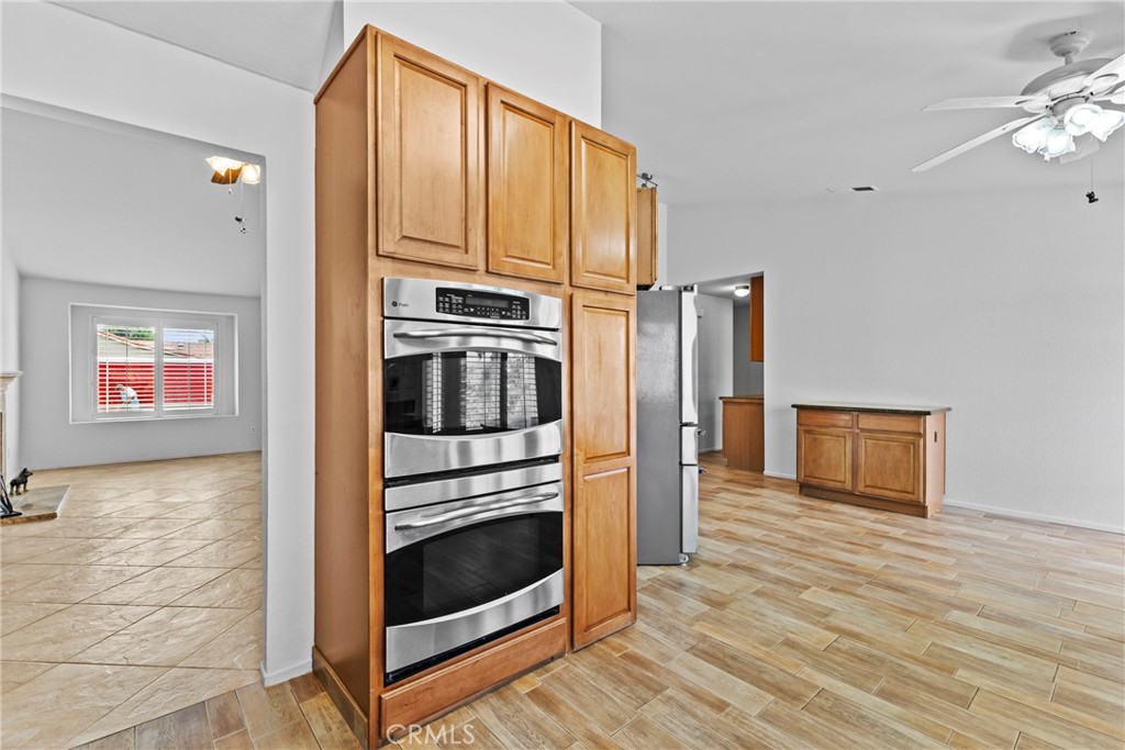 27126 Rio Vista Drive Menifee, CA 92586 - Photo 22 of 47 a kitchen with stainless steel appliances granite countertop a stove and a refrigerator