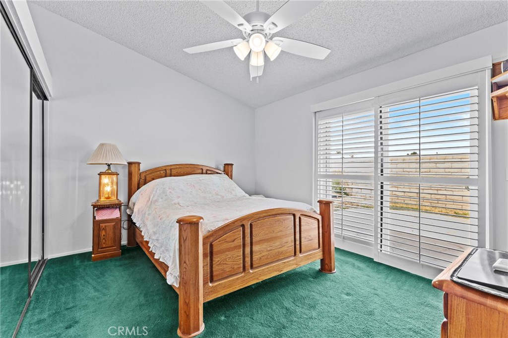 27126 Rio Vista Drive Menifee, CA 92586 - Photo 23 of 47 a bedroom with a bed and a chandelier