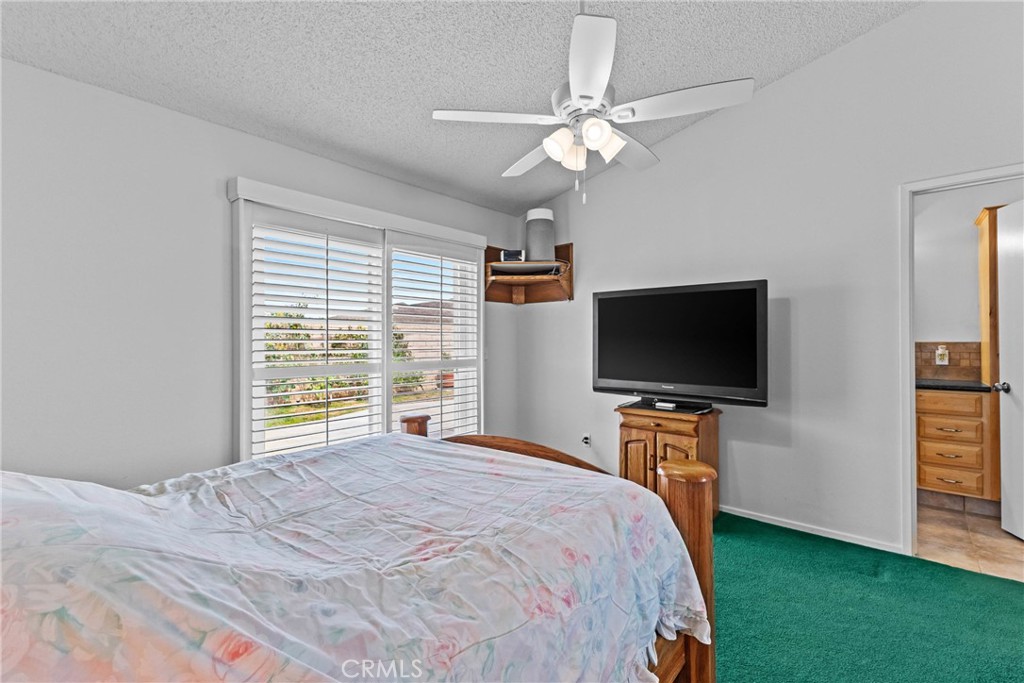 27126 Rio Vista Drive Menifee, CA 92586 - Photo 24 of 47 a bedroom with a bed and a flat screen tv
