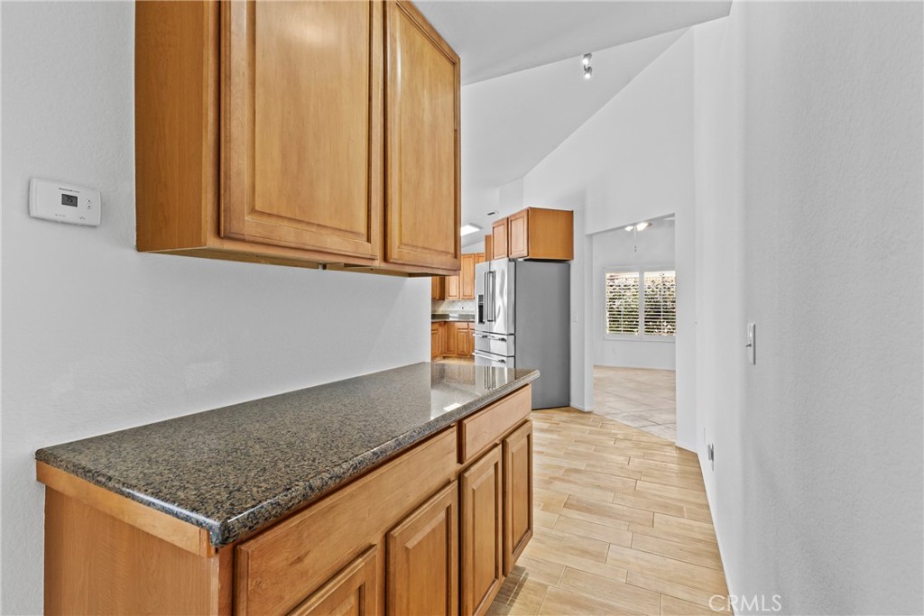 27126 Rio Vista Drive Menifee, CA 92586 - Photo 30 of 47 a kitchen with stainless steel appliances granite countertop a sink and a refrigerator