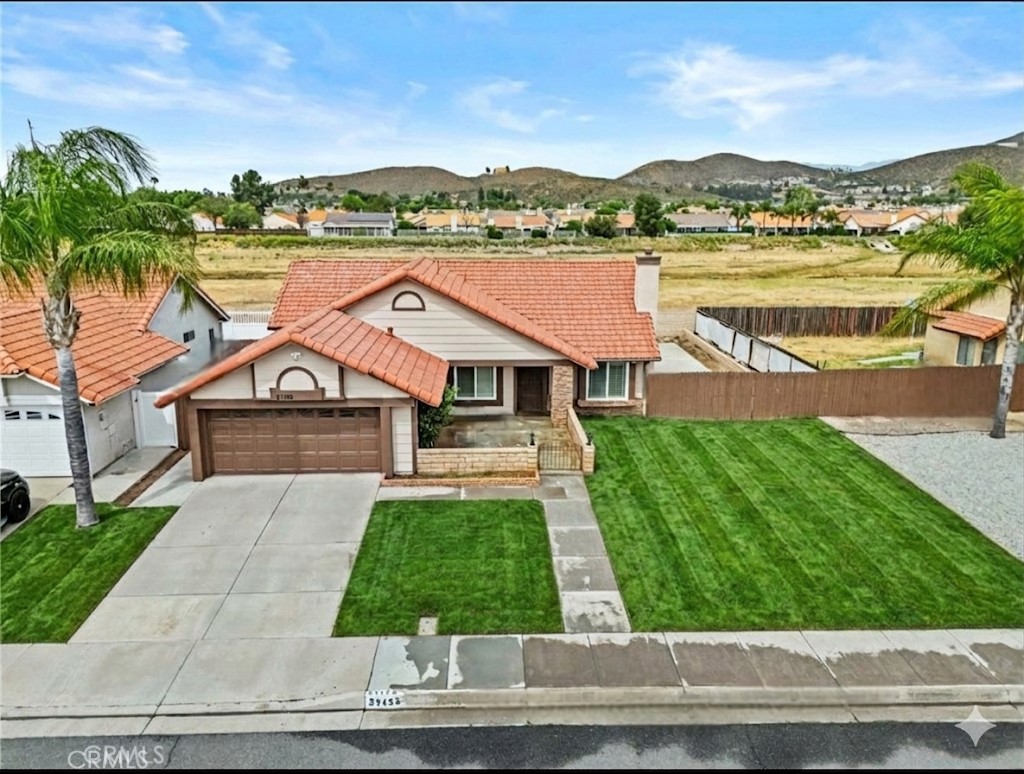 27126 Rio Vista Drive Menifee, CA 92586 - Photo 45 of 47 a front view of house with yard and lake view