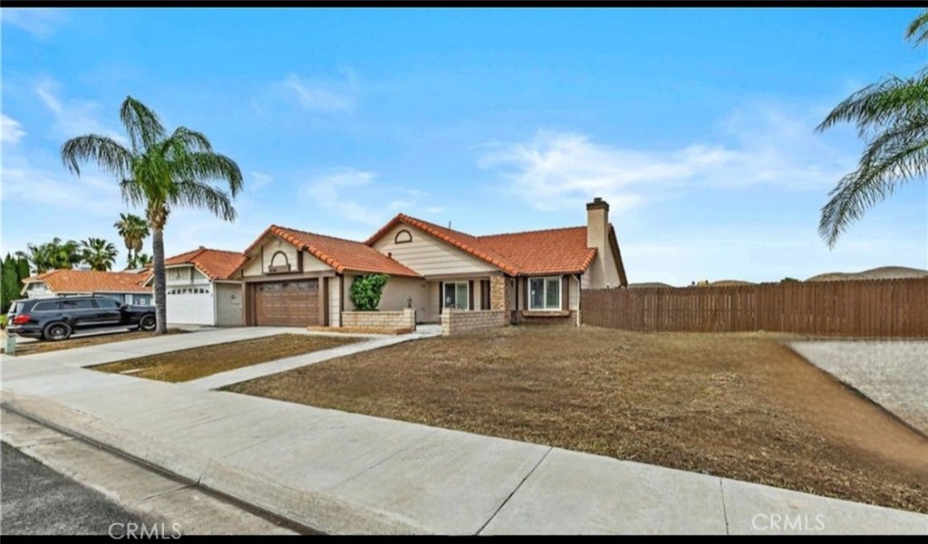 27126 Rio Vista Drive Menifee, CA 92586 - Photo 5 of 47 a front view of a house with a yard and garage