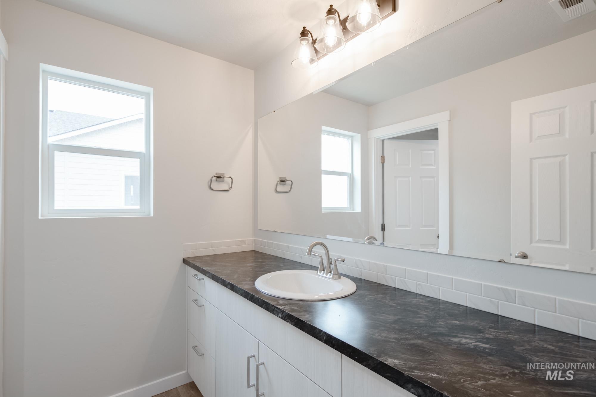 5261 South Memory Avenue Meridian, ID 83642 - Photo 26 of 30 Bathroom featuring vanity and baseboards