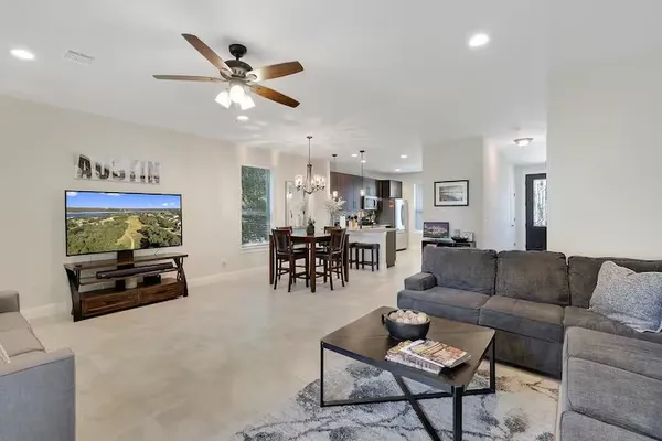 a living room with furniture and a flat screen tv with wooden floor