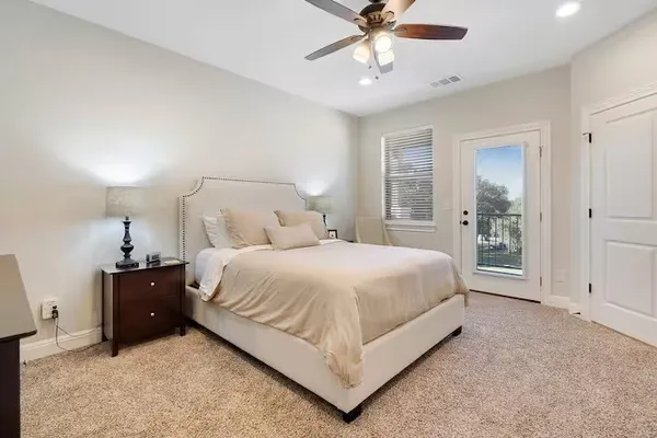 a spacious bedroom with a bed and a chandelier