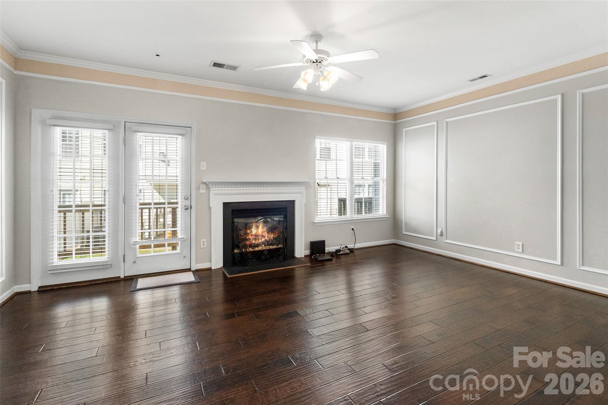 104 Rock Ridge Lane Mount Holly, NC 28120 - Photo 11 of 48 an empty room with wooden floor fireplace and windows