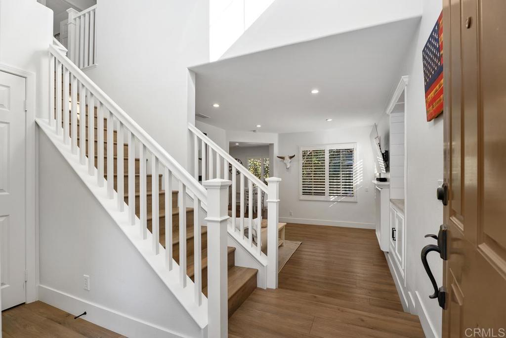 8 Potters Bend Ladera Ranch, CA 92694 - Photo 2 of 42 a view of a hallway with wooden floor and staircase