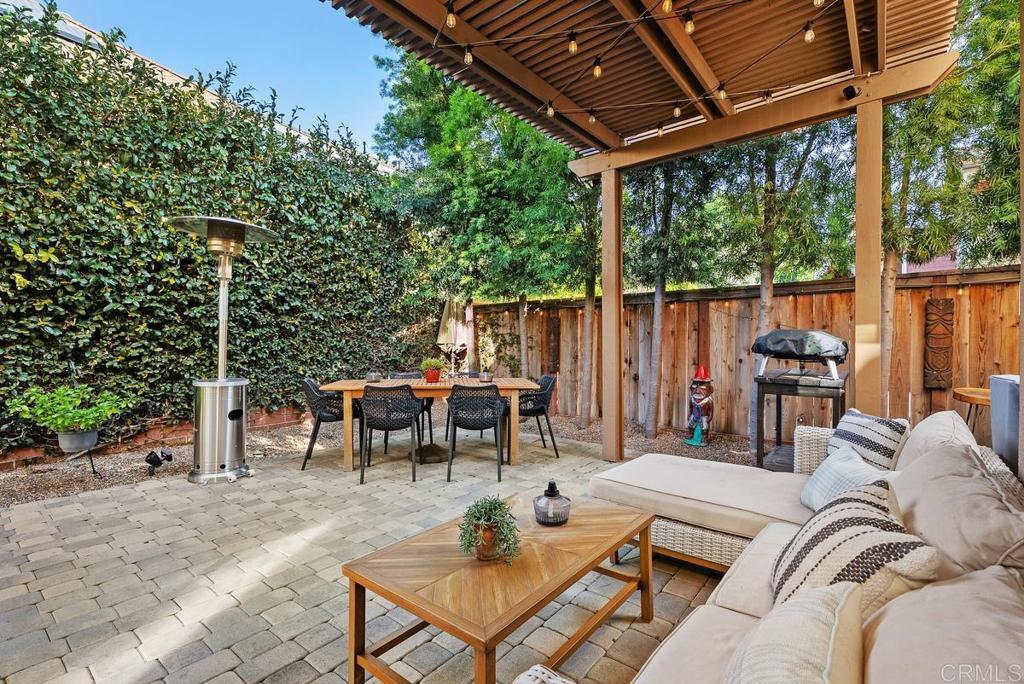 8 Potters Bend Ladera Ranch, CA 92694 - Photo 25 of 42 a view of a patio with a dining table and chairs with wooden floor