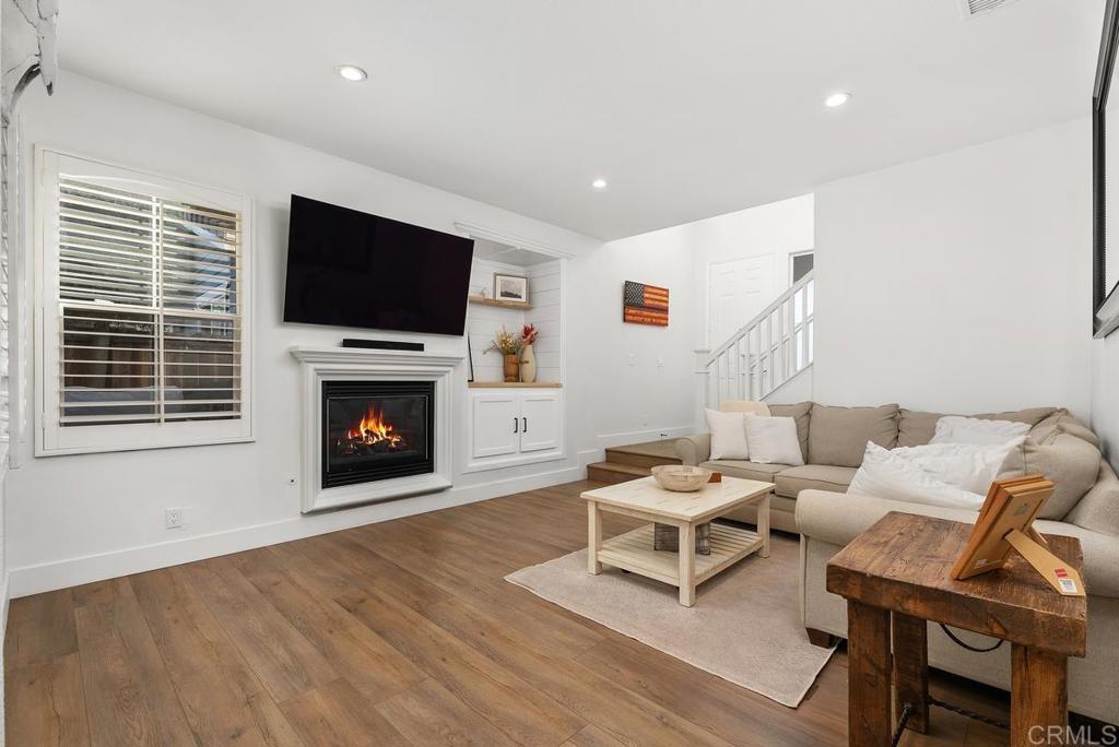 8 Potters Bend Ladera Ranch, CA 92694 - Photo 4 of 42 a living room with furniture a flat screen tv and a fireplace
