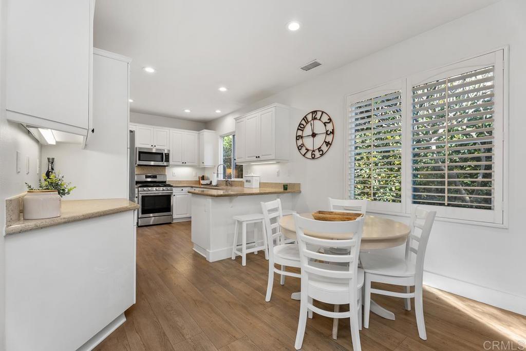 8 Potters Bend Ladera Ranch, CA 92694 - Photo 5 of 42 a view of a dining room with furniture window and wooden floor