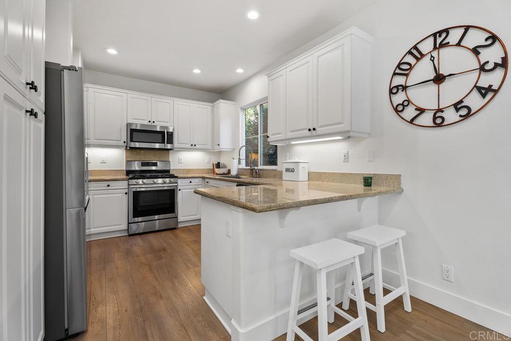 8 Potters Bend Ladera Ranch, CA 92694 - Photo 7 of 42 a kitchen with granite countertop white cabinets and stainless steel appliances