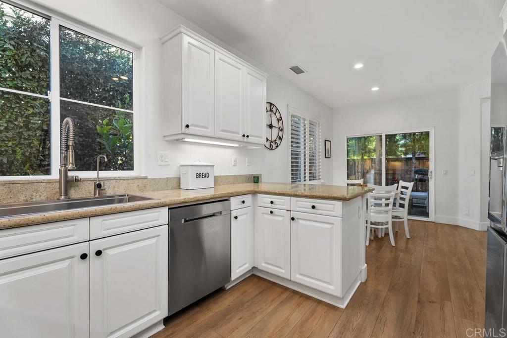 8 Potters Bend Ladera Ranch, CA 92694 - Photo 10 of 42 a kitchen with a sink cabinets and wooden floor