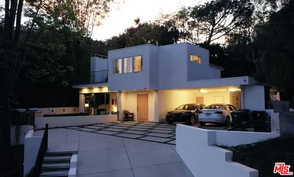 a large parking space in front of the house