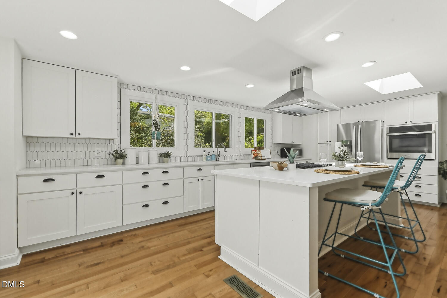 3704 Swann Street Raleigh, NC 27612 - Photo 6 of 21 a kitchen with white cabinets and sink