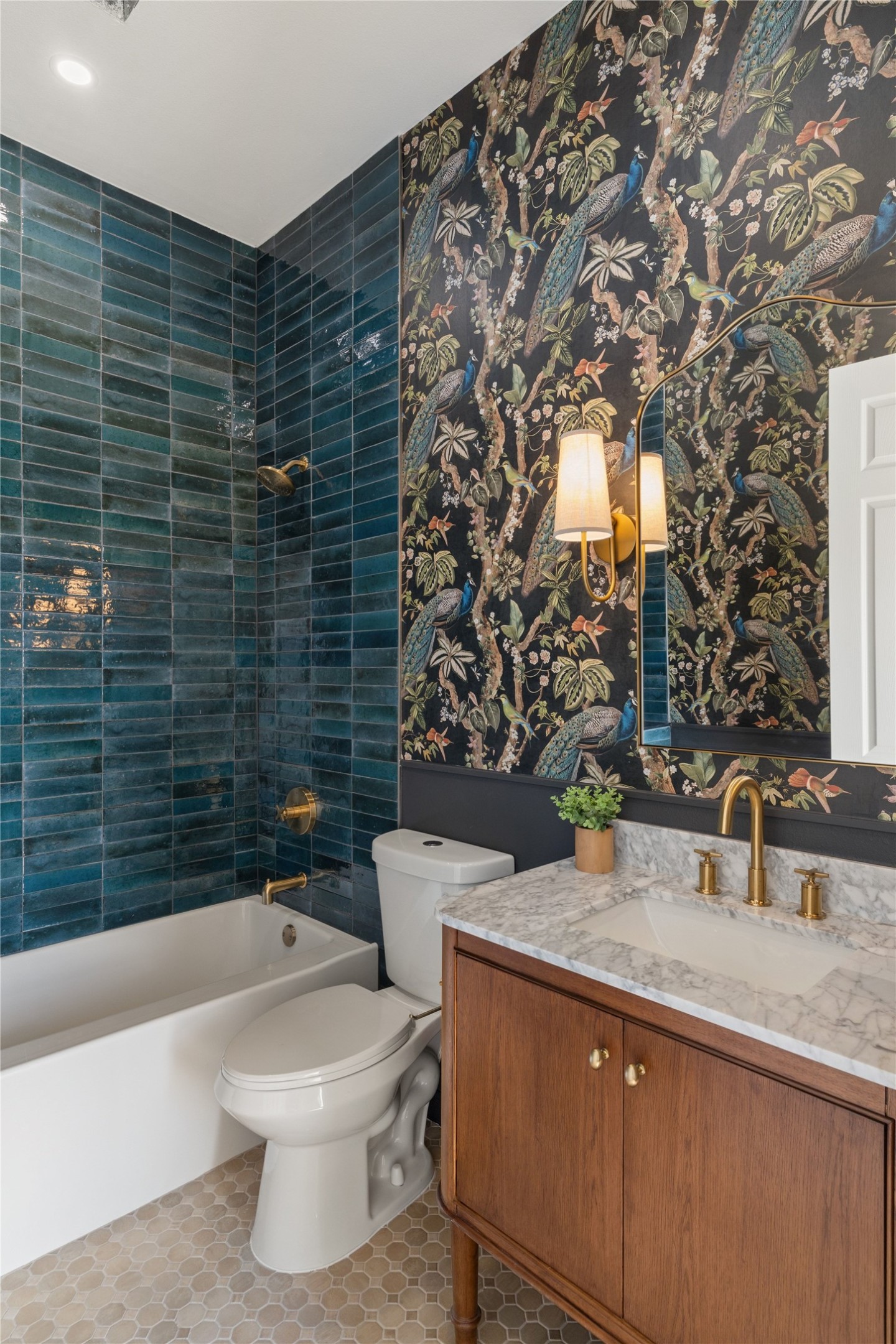 601 Hays Country Acres Road Dripping Springs, TX 78620 - Photo 24 of 38 Gleaming wall tiles and a rich stone-topped vanity define this curated washroom space.