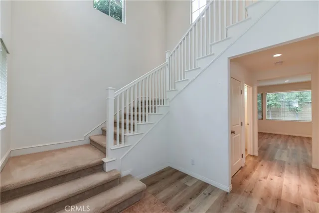 a view of staircase with white walls and windows