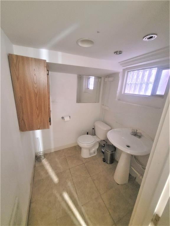 263 Robinson Street Pittsburgh, PA 15213 - Photo 18 of 21 a bathroom with a sink a toilet and mirror