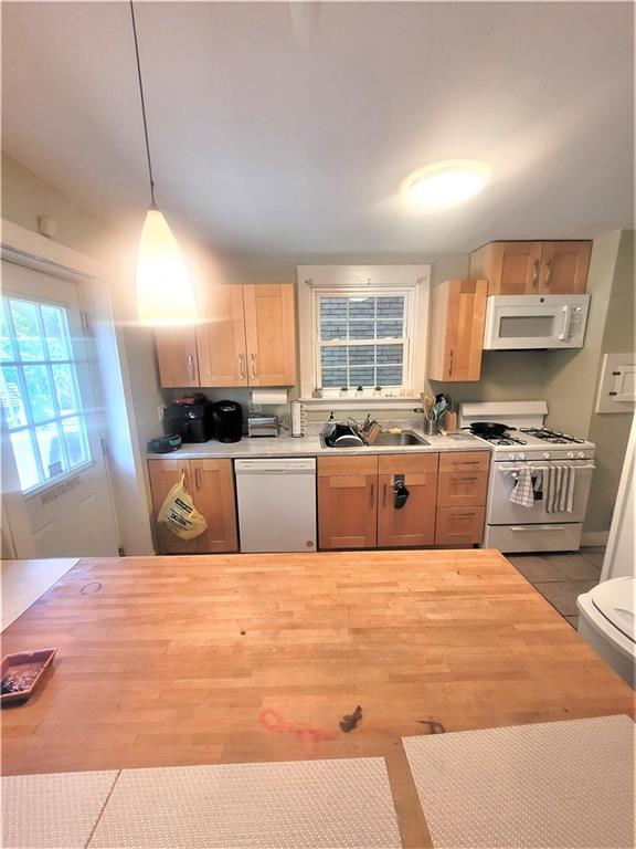 263 Robinson Street Pittsburgh, PA 15213 - Photo 5 of 21 a large kitchen with stainless steel appliances kitchen island a stove a sink dishwasher a microwave oven with cabinets and wooden floor