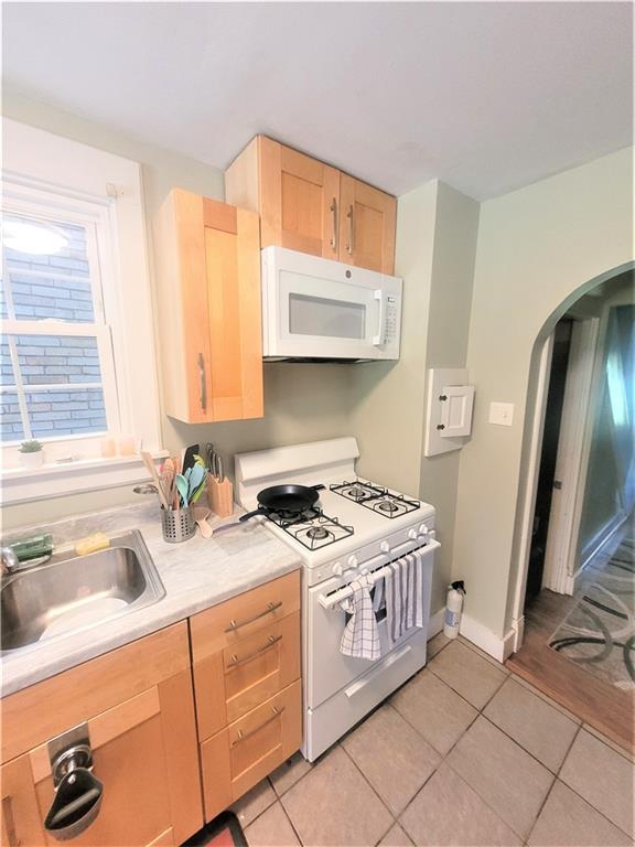 263 Robinson Street Pittsburgh, PA 15213 - Photo 7 of 21 a kitchen that has a sink a stove and a window