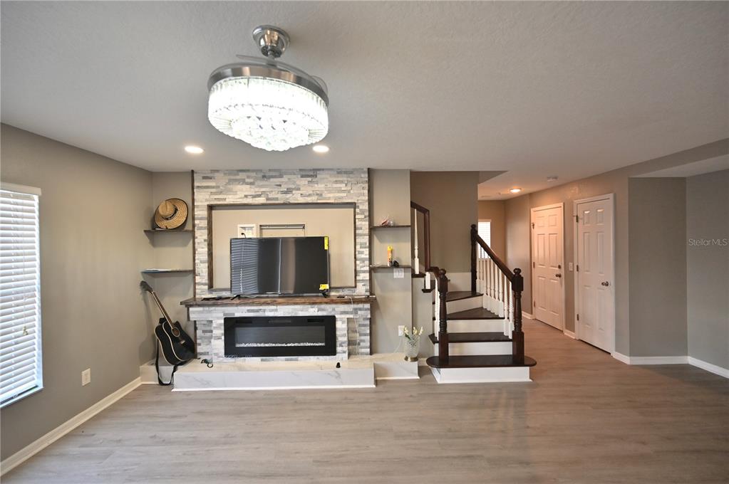 10922 Subtle Trail Drive Riverview, FL 33579 - Photo 11 of 60 a view of a livingroom with a fireplace stairs and windows