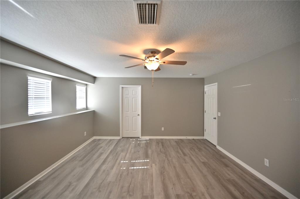 10922 Subtle Trail Drive Riverview, FL 33579 - Photo 14 of 60 wooden floor in an empty room with a window