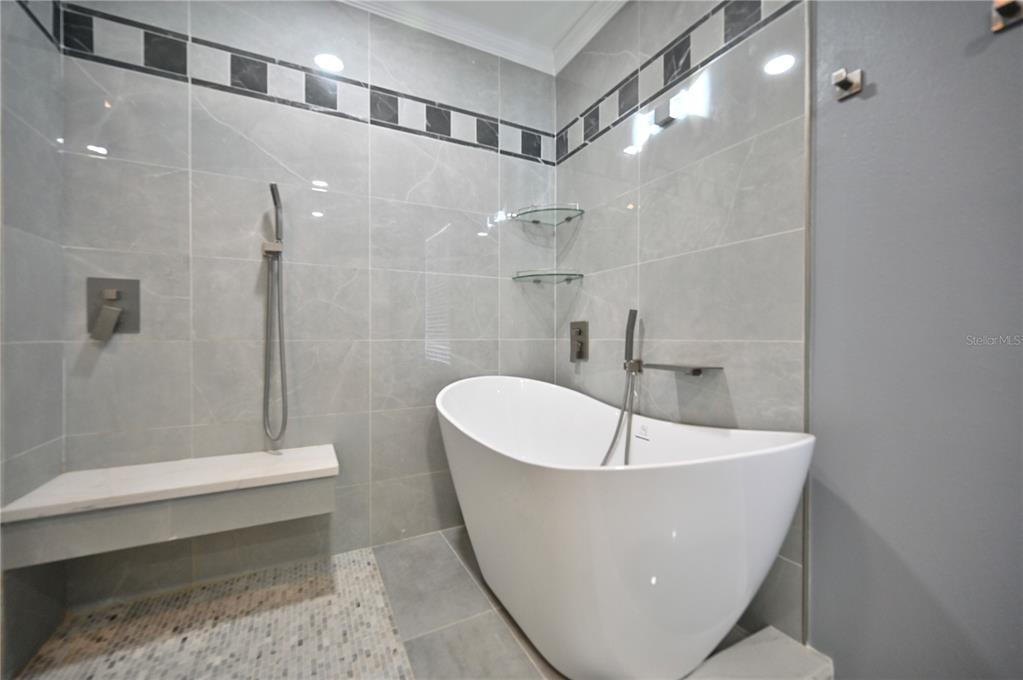 10922 Subtle Trail Drive Riverview, FL 33579 - Photo 19 of 60 a white bath tub sitting in a bathroom and shower