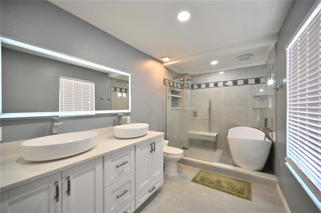 10922 Subtle Trail Drive Riverview, FL 33579 - Photo 23 of 60 a bathroom with a double vanity sink toilet and shower
